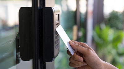 An employee tapping their card at an access control point