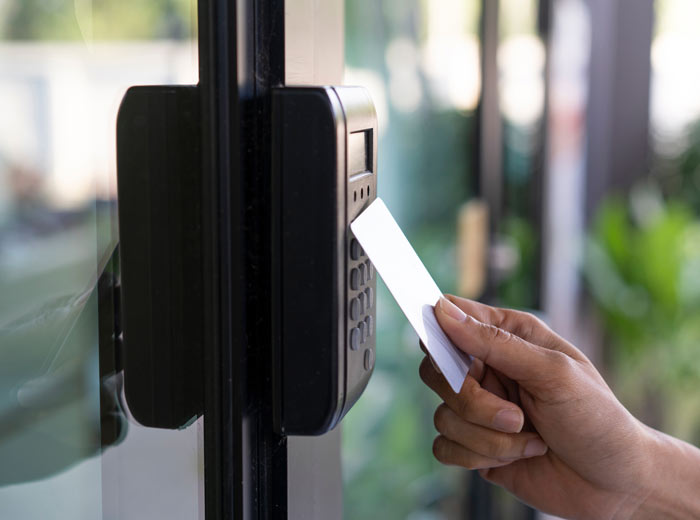 An employee tapping their card at an access control point