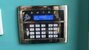 security alarm system control panel with digital display showing IDA Alarms Ltd and the time 12:26 c